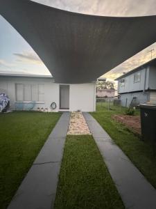 a house with a large roof over a sidewalk at Large Earthy toned Apartment in Ross River