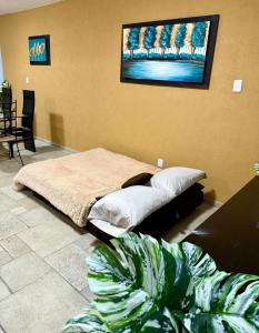 a bedroom with a bed and two potted plants at Marina Diamante Plata D5 in Acapulco +42 photos
