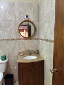 a bathroom with a sink and a mirror at Villa Azure in Tower Isle