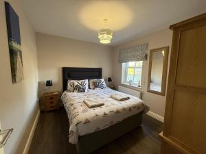 a bedroom with a bed with two towels on it at 12 Green Close at The Bay Filey, sleeps 8, 2 dogs welcome for free too in Filey +24 photos