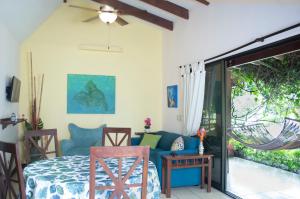 a bedroom with a blue bed and a sliding glass door at Apartments-Villas Playa Potrero 1 in Potrero