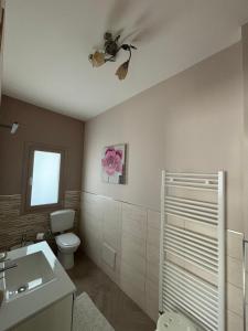 a bathroom with a toilet and a ceiling fan at Aidone Sunset House in Aidone +16 photos