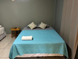 a bedroom with a blue bed with a blue blanket at RodMar Hotel in El Cuco +26 photos