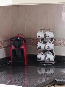 a pile of cups hanging on a wall at Entre Mar y Montañas in Vall de Uxó