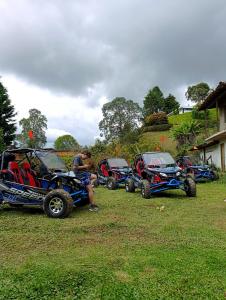 a group of four four wheelers parked in a field at La Casa de Blue in Guarne