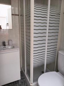 a bathroom with a shower with a toilet and a sink at Entre Mar y Montañas in Vall de Uxó +10 photos