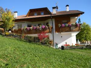 a house with flowers on the balconies at Unterweger Hof in Avelengo