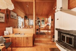 a living room with wood paneling and a fireplace at Villa Polaris in Äkäslompolo