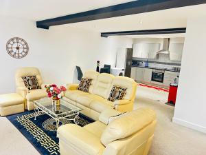 a living room with two couches and a table at Doncaster 2 Bedroom Luxury Apartment in Doncaster