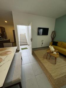a living room with a couch and a table at El Departamento Playa Sur in Mazatlán
