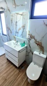 a bathroom with a white sink and a toilet at Quinta da Toqueira in Canedo +32 photos