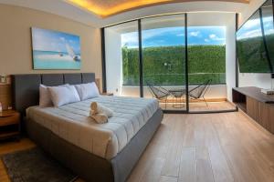 a bedroom with a bed with a teddy bear on it at Beachside Studio & Jacuzzi Bliss in Playa del Carmen