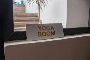 a sign that says yoga room on top of a wall at Beachside Studio & Jacuzzi Bliss in Playa del Carmen +6 photos