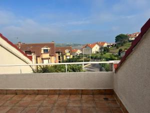 a balcony with a view of a city at Atico con terraza al mar in Mogro