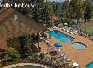 an overhead view of a swimming pool with chairs and umbrellas at Fall Season Mtn Views, Hot Tub, Sauna, close to Downtown! in Gatlinburg