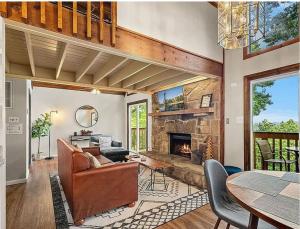 a living room with a couch and a fireplace at Fall Season Mtn Views, Hot Tub, Sauna, close to Downtown! in Gatlinburg