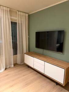 a living room with a flat screen tv on the wall at Gardermoen Airport, 5Min in Sand