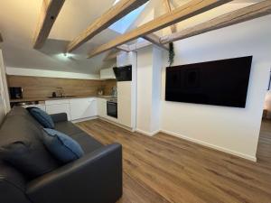 a living room with a couch and a flat screen tv at Melem Apartments 2 in Langen