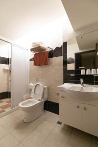 a bathroom with a toilet and a sink at Home Rest B&B in Lijia +51 photos