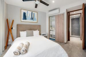 a bedroom with a large white bed with white sheets at 2bed apartment 500m from beach in Playa del Carmen +48 photos