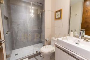 a bathroom with a shower and a toilet and a sink at Luxury Condo in central location in Playa del Carmen