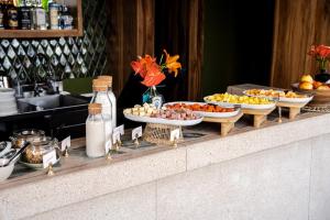 a buffet of food on a counter with plates of food at Urbit Social Lofts in Medellín