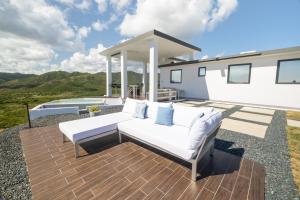 a white couch on a wooden deck with a house at Vista Serena in Salinas