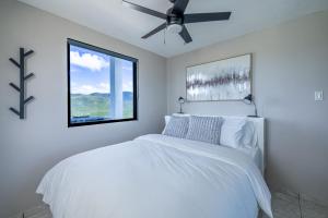 a white bedroom with a bed with a ceiling fan at Vista Serena in Salinas +55 photos