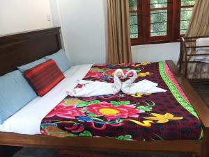 a bed with two swans on top of it at Rock View Rest Hatton in Hatton +8 photos