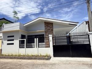 a white house with a black garage at The Eastcape by Akeisha in Bacolod