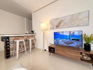 a living room with a large flat screen tv at The Eastcape by Akeisha in Bacolod