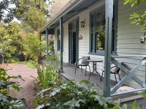 a porch of a house with a table and chairs at Bromwich Guest House - 250m to town centre! in Blackwood