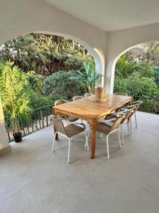 a wooden table and chairs on a patio at Villa Paz in El Campello