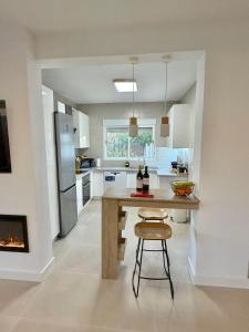 a kitchen with a wooden table and a stove at Villa Paz in El Campello +23 photos