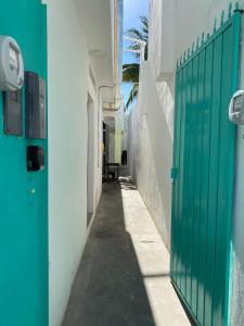 a hallway of a house with a green gate at Casa Alberto Cozumel in Cozumel