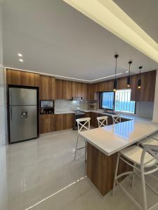 a kitchen with a table and chairs and a refrigerator at Paradise Palms Vacation Rentals in Mīdān az Zīr