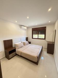 a bedroom with a large bed and a window at Paradise Palms Vacation Rentals in Mīdān az Zīr +60 photos