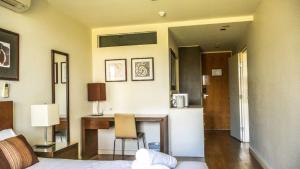 a bedroom with a desk and a bed and a room at Resort Two Bedroom 275 in Torquay