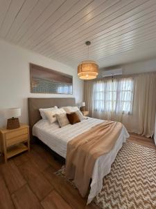 a bedroom with a large bed and a chandelier at El Refugio Lodge in Corrientes +79 photos