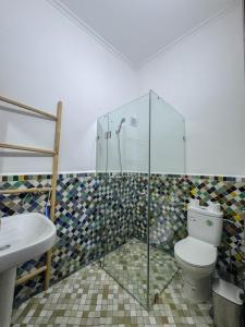 a bathroom with a shower and a toilet and a sink at Riad Azul Fes & SPA in Fez +97 photos