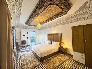 a bedroom with a large bed with a large ceiling at Riad Azul Fes & SPA in Fez