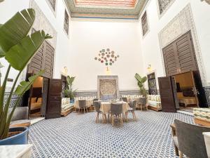 a dining room with tables and chairs and a ceiling at Riad Azul Fes & SPA in Fez