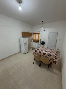 a kitchen with a table and chairs in a room at Apart Sur Catriel in Catriel