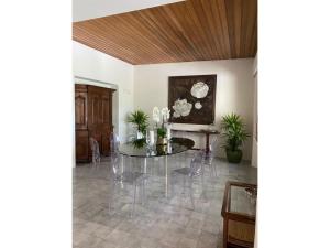 a dining room with a glass table and chairs at Villa Rocchetta in Casa Mora +32 photos