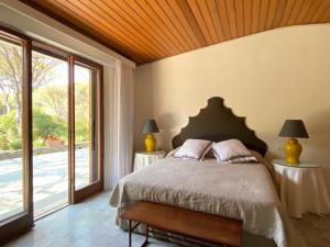 a bedroom with a bed and a large window at Villa Rocchetta in Casa Mora