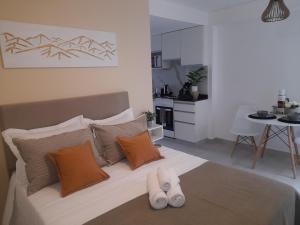 a bedroom with a bed with two white shoes on it at Legui Suites in Salta
