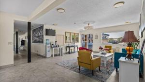 a living room with a couch and a table at Red Arrow Inn & Suites, a Travelodge by Wyndham in Montrose