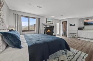a bedroom with a large bed and a fireplace at Fall Season Mtn Views, Hot Tub, Sauna, close to Downtown! in Gatlinburg +19 photos