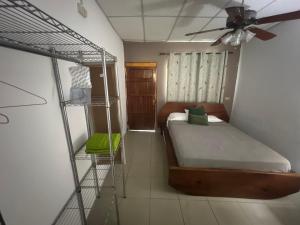 a bedroom with a bunk bed and a ceiling fan at Pumila House in Villa Rosario