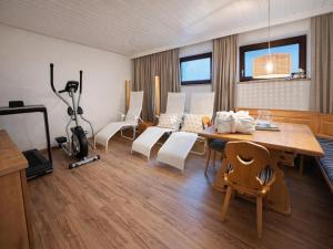 a living room with a wooden table and white chairs at Luxury Central Kirchberg in Kirchberg in Tirol